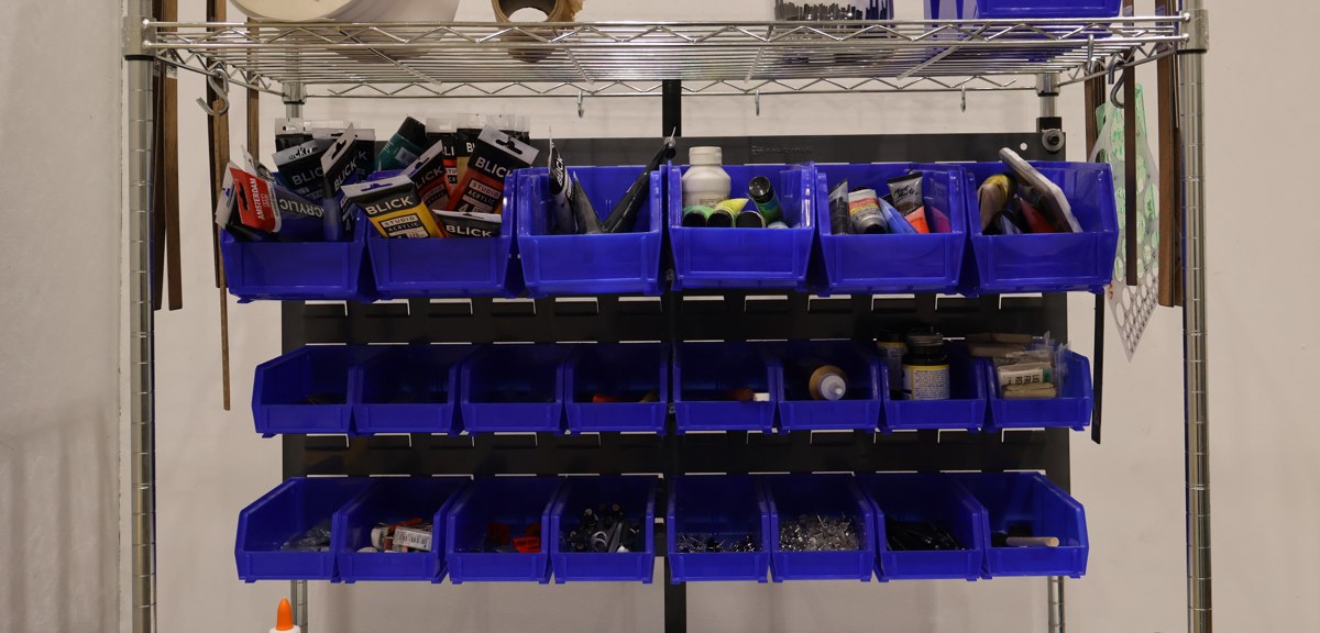Shop shelf with labeled parts bins, the kind of small-parts inventory SmartFlow tracks